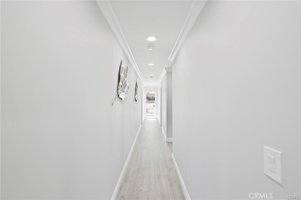 112 Van Nuys Avenue Oxnard, CA 93035 - Photo 48 of 58 a view of a hallway with wooden floor and a white wall