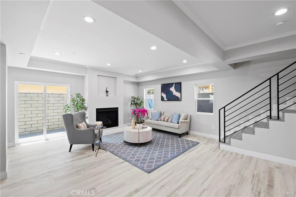 112 Van Nuys Avenue Oxnard, CA 93035 - Photo 54 of 58 a living room with fireplace furniture and a wooden floor