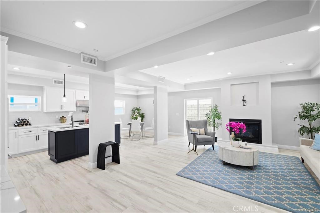 112 Van Nuys Avenue Oxnard, CA 93035 - Photo 6 of 58 a living room with furniture and a wooden floor