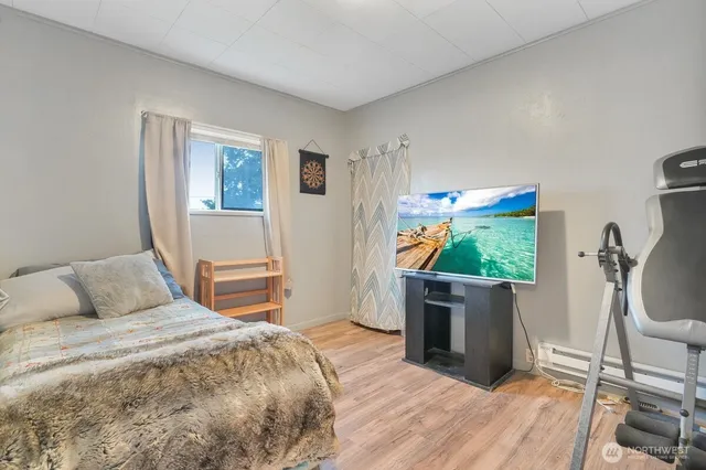 a bedroom with a bed and a flat screen tv