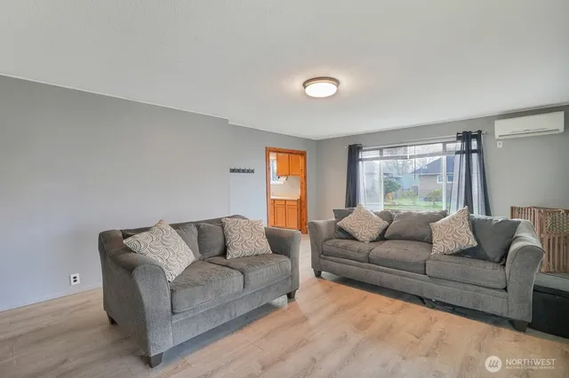 a living room with furniture and a large window