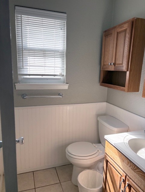 1917 Castle Gate Circle San Marcos, TX 78666 - Photo 13 of 21 Bathroom featuring wainscoting, vanity, and light tile patterned floors