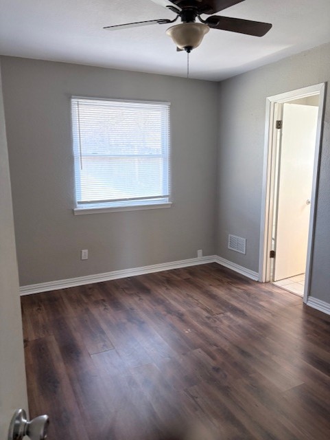 1917 Castle Gate Circle San Marcos, TX 78666 - Photo 17 of 21 Spare room featuring a ceiling fan and dark wood-type flooring