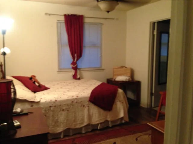 a bedroom with a bed and a window