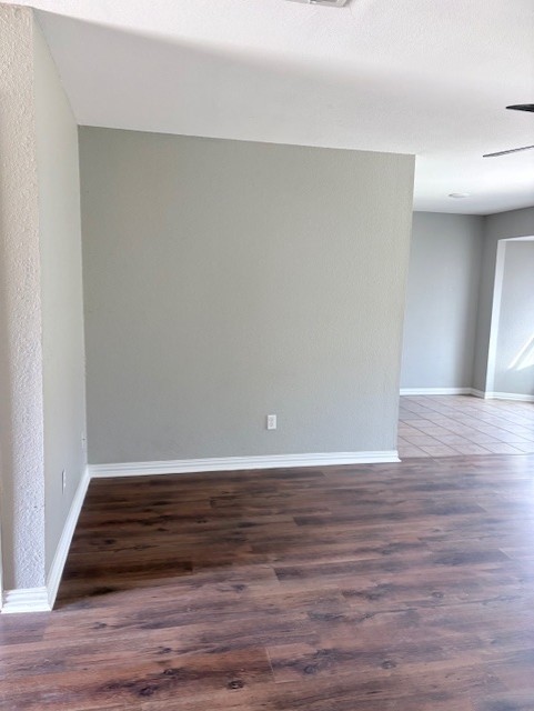 1917 Castle Gate Circle San Marcos, TX 78666 - Photo 3 of 21 Empty room featuring dark wood finished floors and ceiling fan
