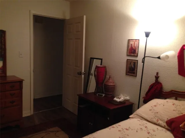 a bedroom with a bed and a mirror