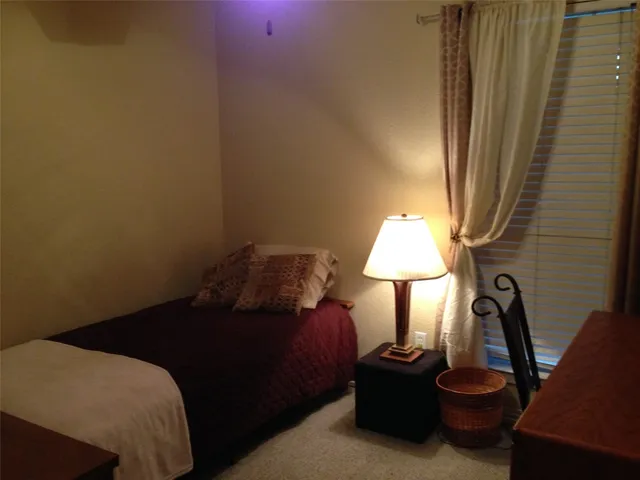 a bedroom with a bed and a table