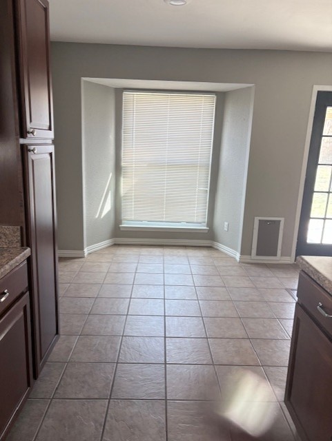 1917 Castle Gate Circle San Marcos, TX 78666 - Photo 8 of 21 Unfurnished dining area featuring light tile patterned floors