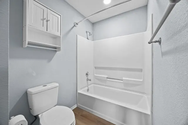 a bathroom with a toilet and a bathtub