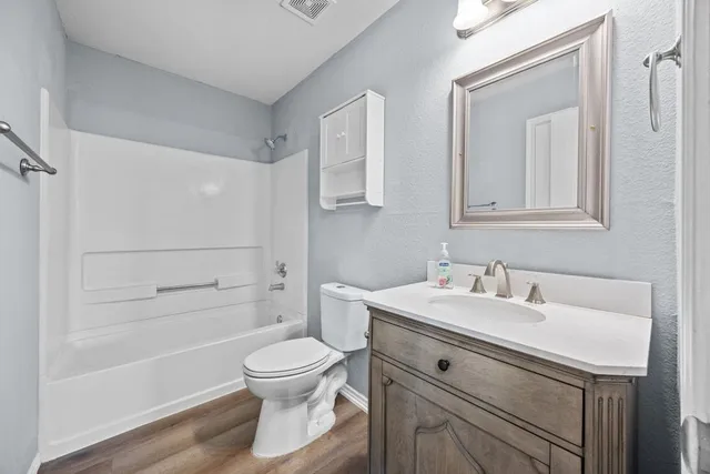 a bathroom with a sink toilet a vanity and shower