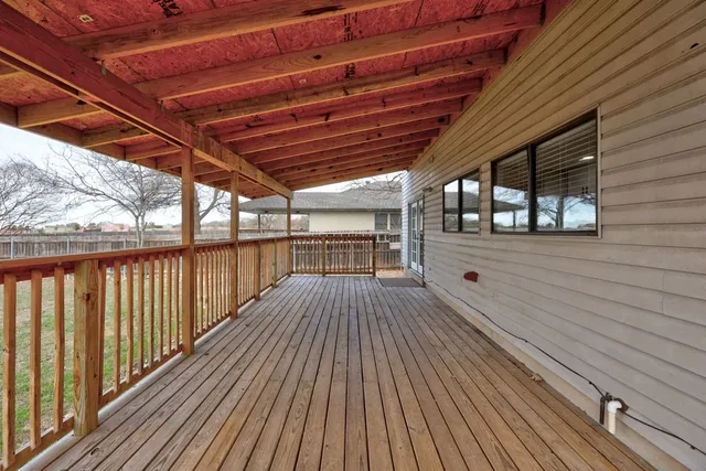 a view of a balcony with wooden floor