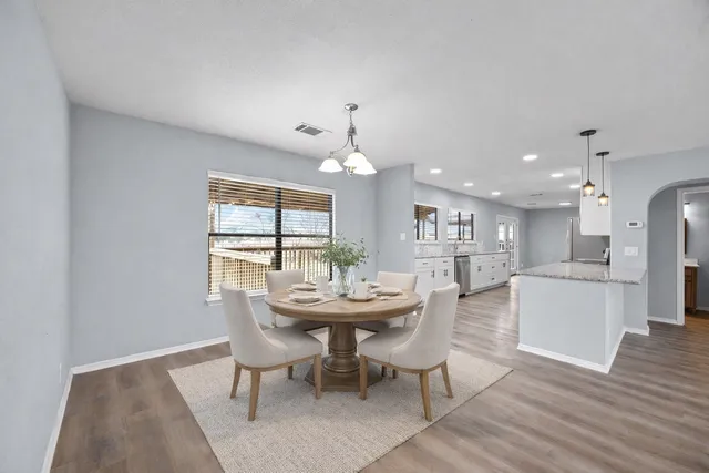 a dining room with furniture and window