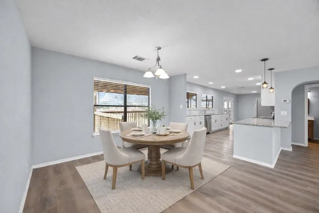 a dining room with furniture and window