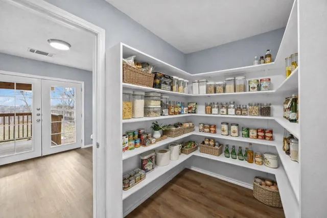a view of an empty room with furniture and book shelf