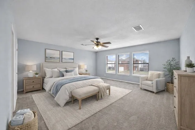 a spacious bedroom with a bed and large window