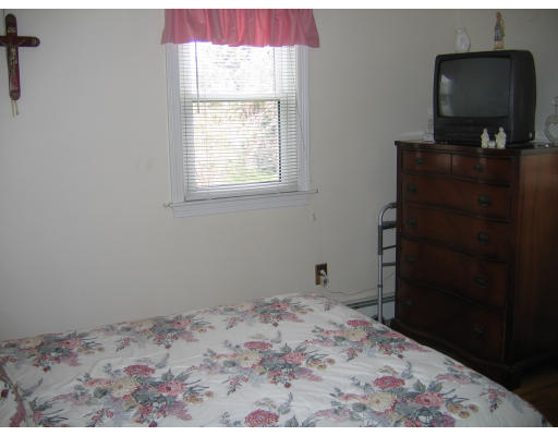 1 Samoset Road Woburn, MA 01801 - Photo 8 of 11 a bedroom with a bed and a window