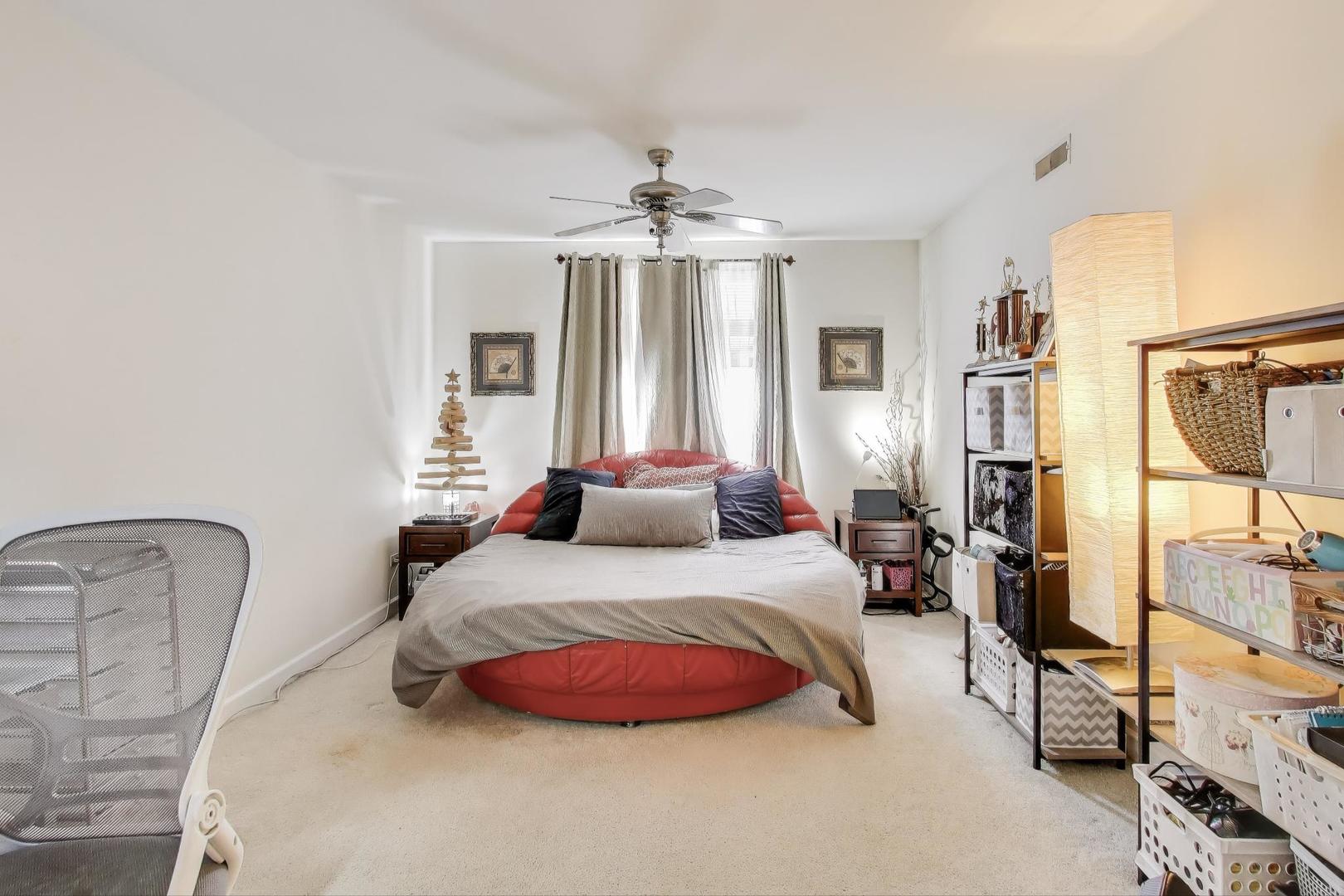 8300 Callie Avenue, Unit 310 Morton Grove, IL 60053 - Photo 14 of 25 a bedroom with a bed mirror and window