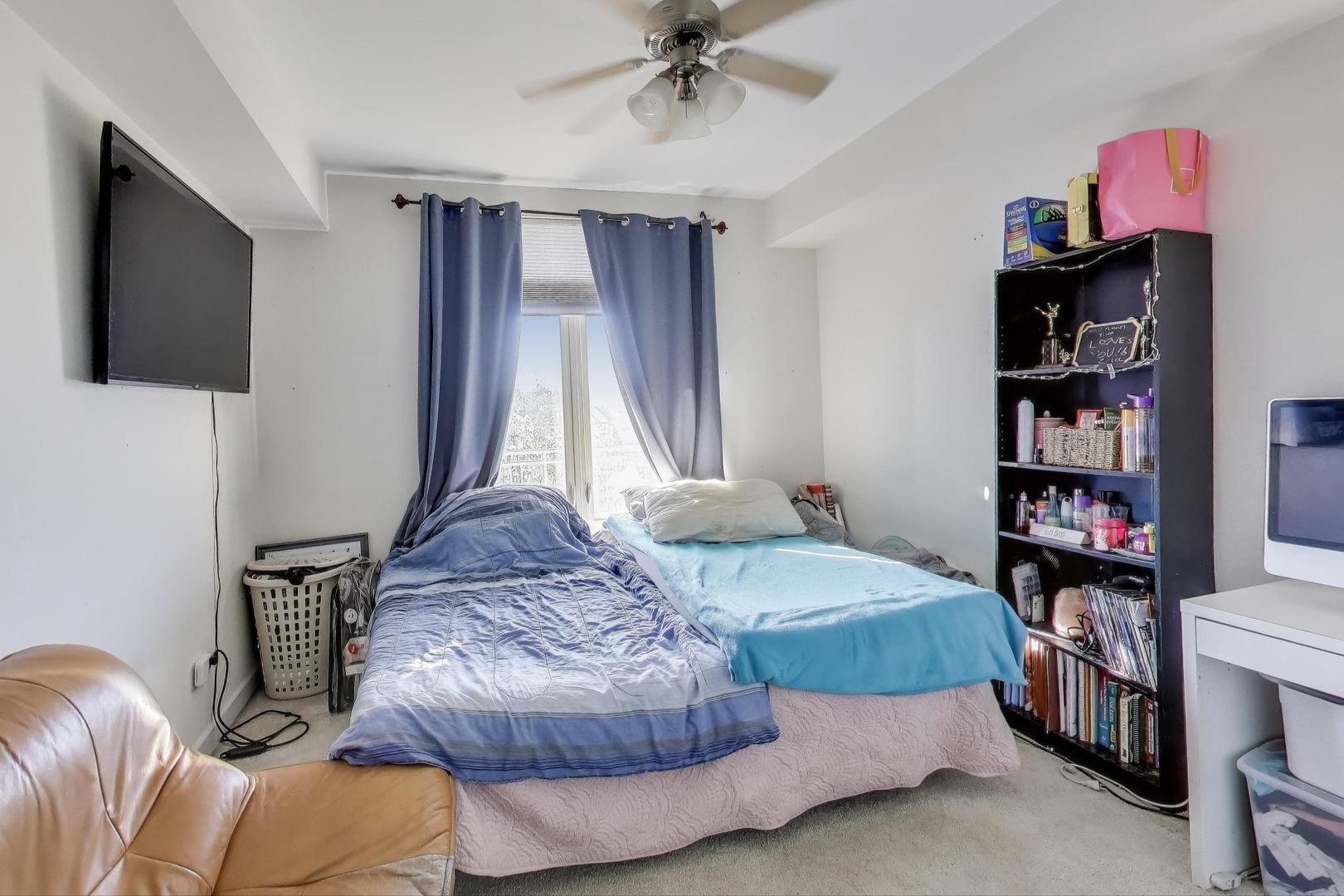 8300 Callie Avenue, Unit 310 Morton Grove, IL 60053 - Photo 17 of 25 a bedroom with a bed and a book shelf