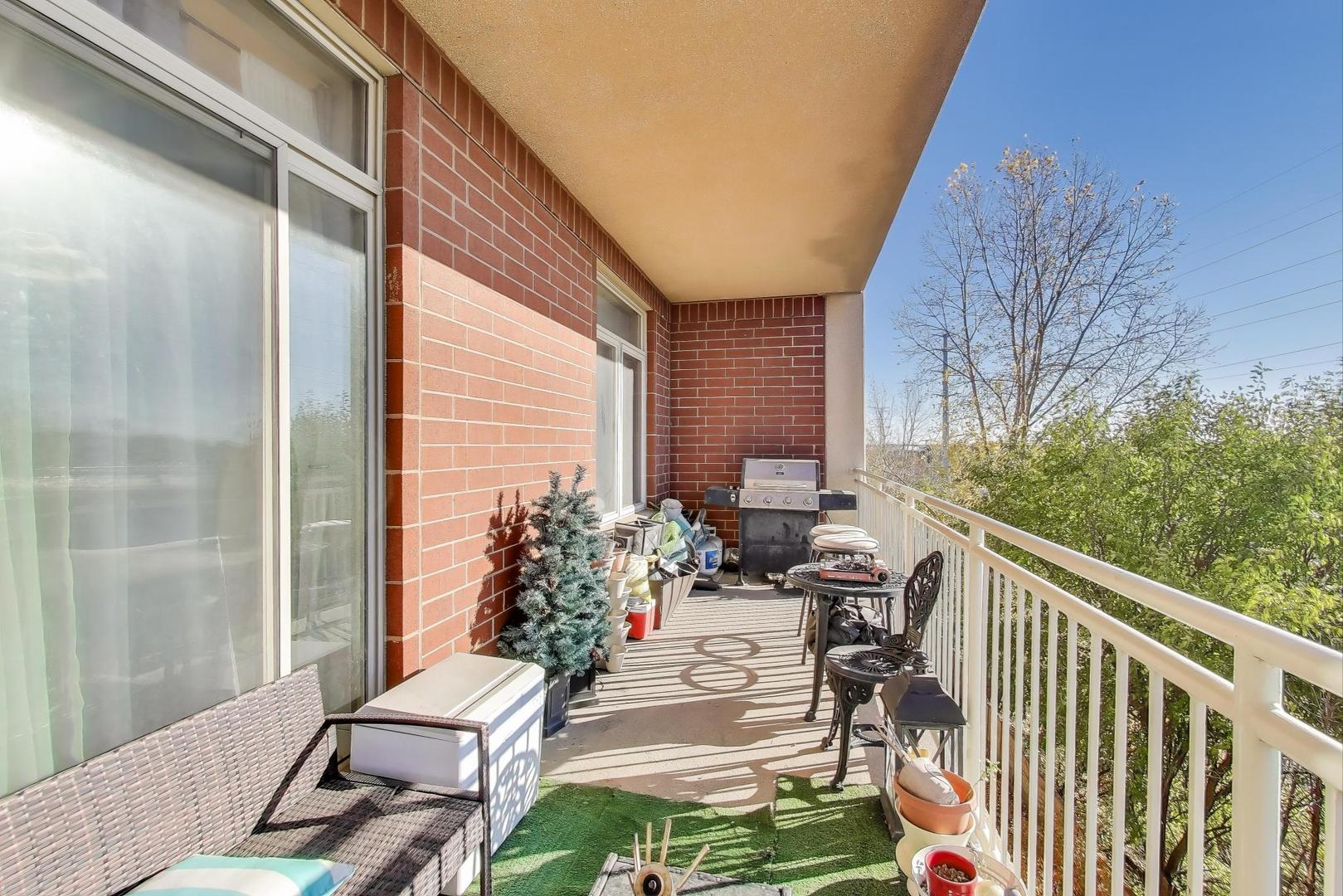 8300 Callie Avenue, Unit 310 Morton Grove, IL 60053 - Photo 21 of 25 a balcony with furniture and flowers