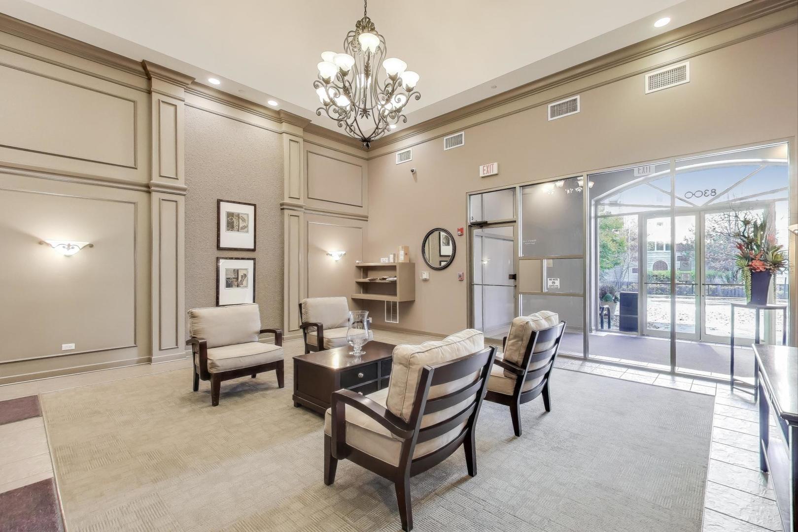 8300 Callie Avenue, Unit 310 Morton Grove, IL 60053 - Photo 5 of 25 a living room with furniture and a chandelier