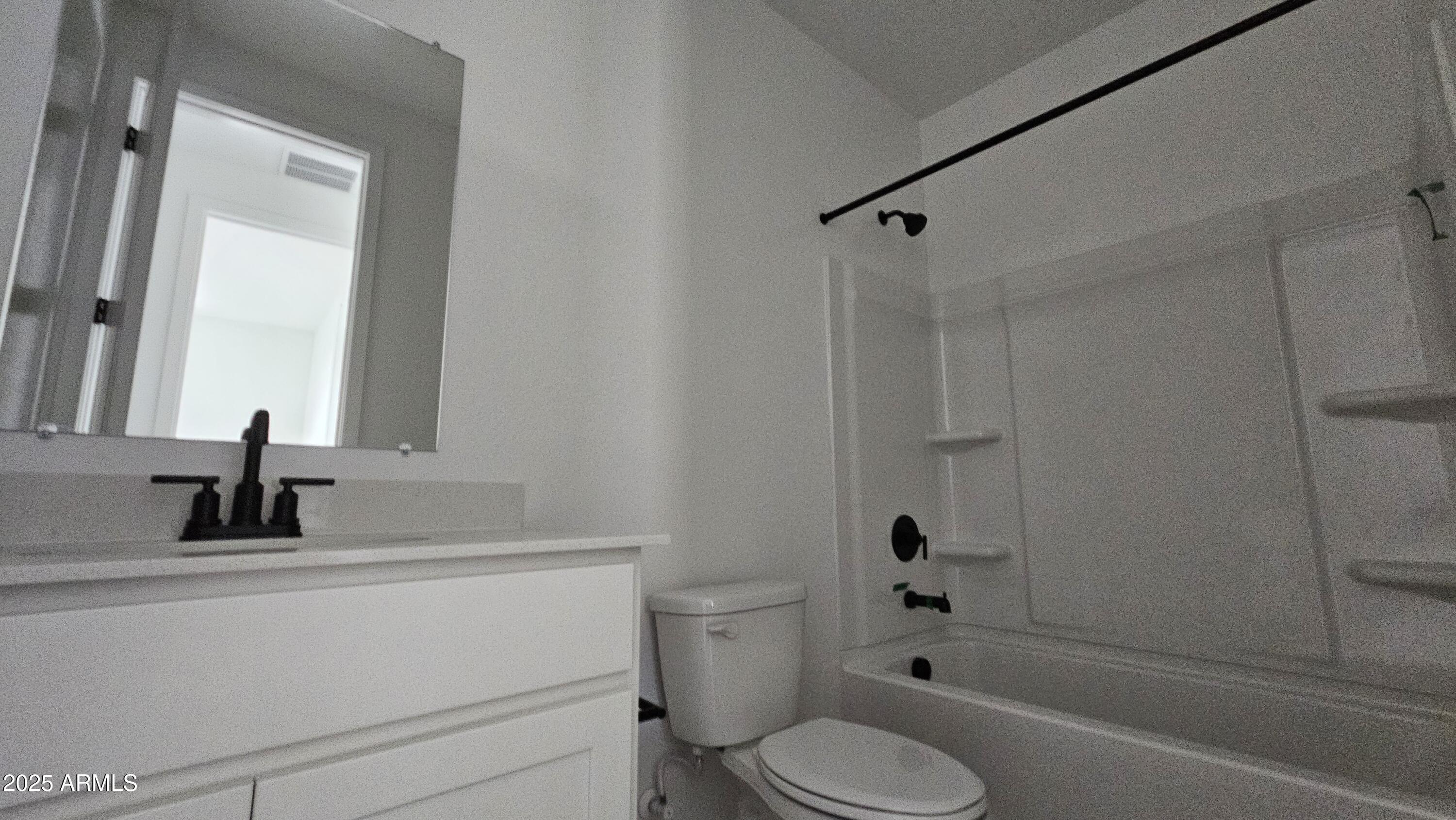 6443 East Fiddleneck Street San Tan Valley, AZ 85140 - Photo 11 of 26 a bathroom with a sink toilet a shower and a mirror