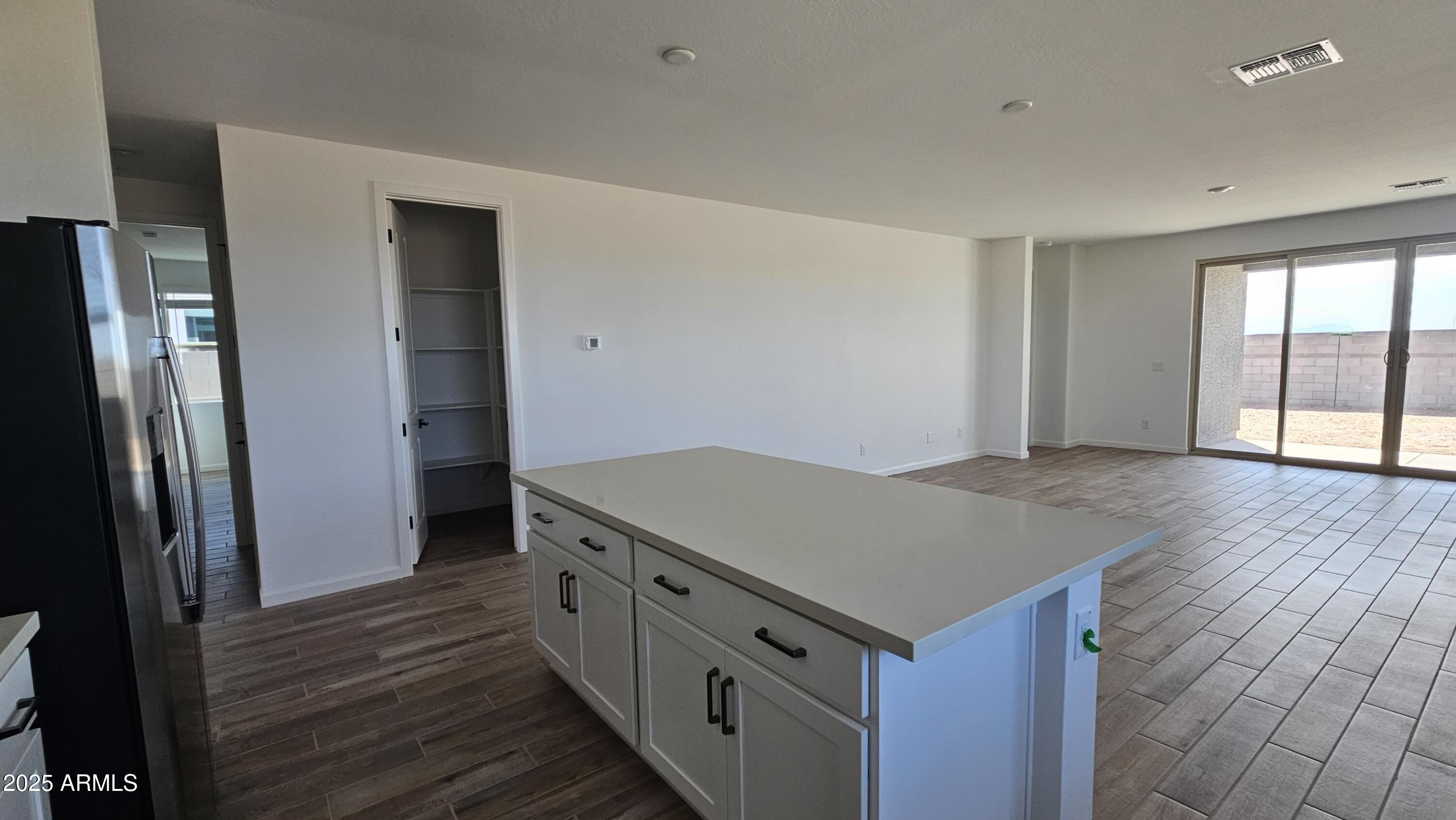 6443 East Fiddleneck Street San Tan Valley, AZ 85140 - Photo 13 of 26 an empty room with wooden floor and entrance