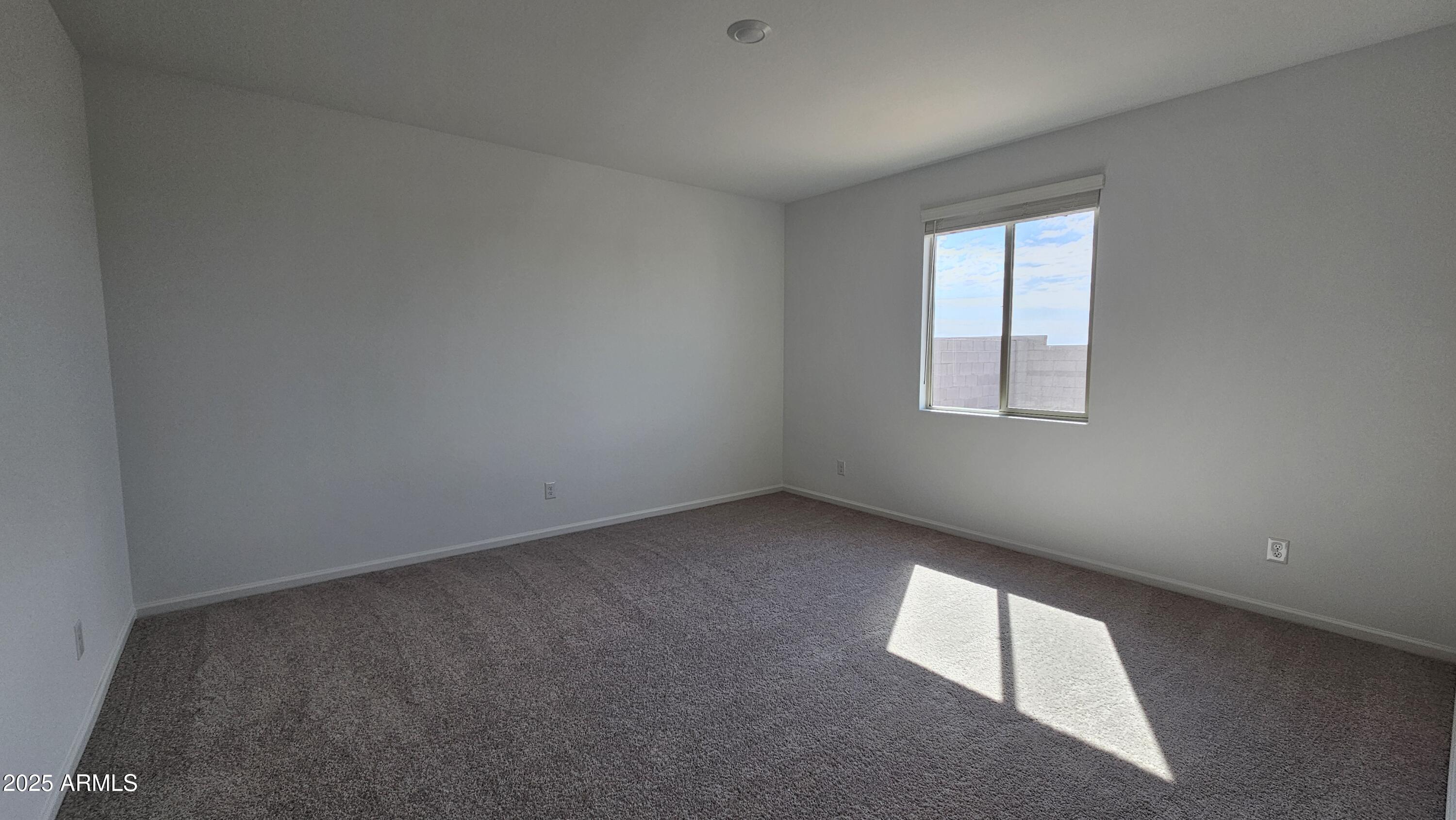 6443 East Fiddleneck Street San Tan Valley, AZ 85140 - Photo 16 of 26 an empty room with a window