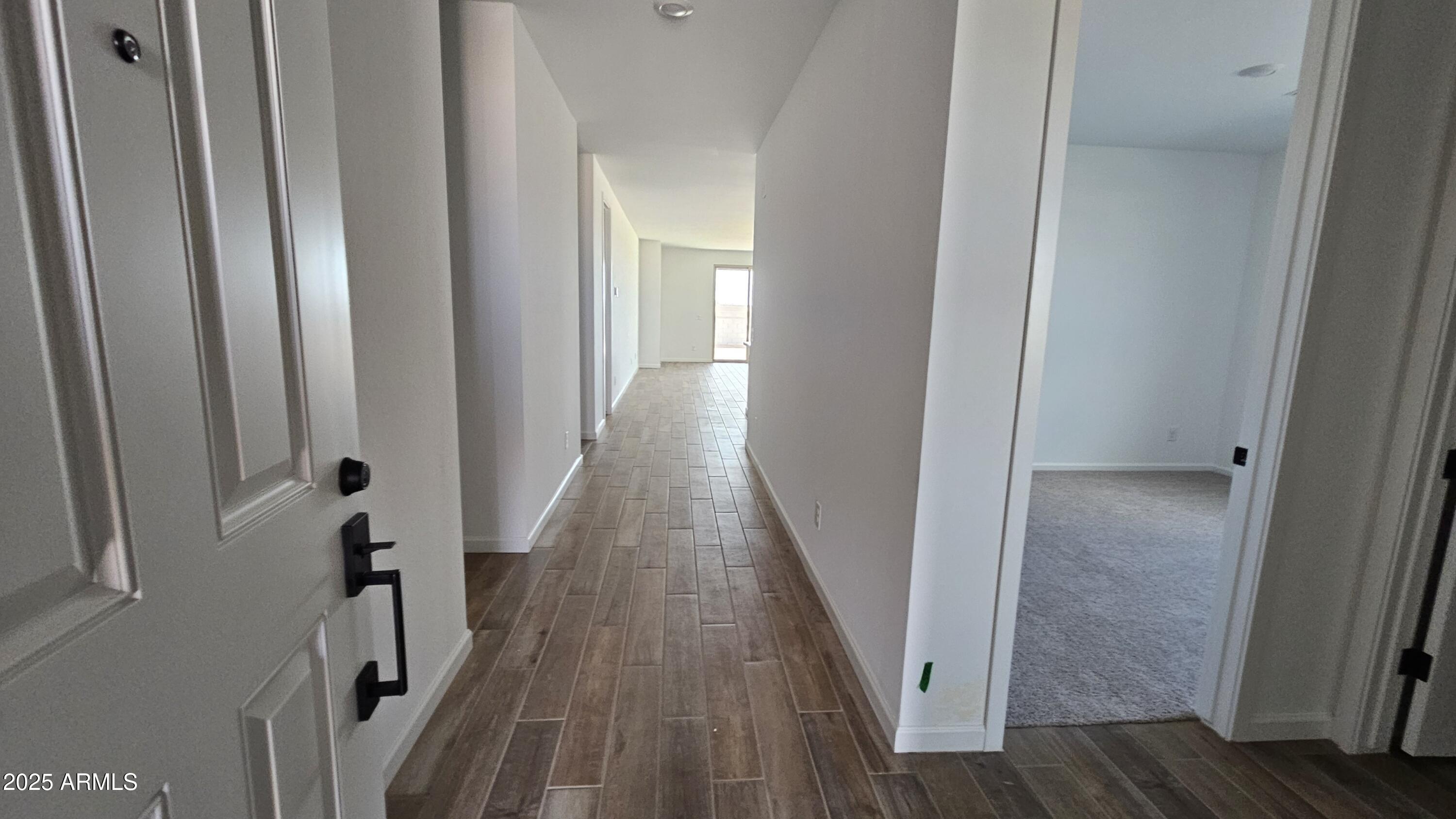 6443 East Fiddleneck Street San Tan Valley, AZ 85140 - Photo 4 of 26 a view of a hallway with wooden floor and staircase