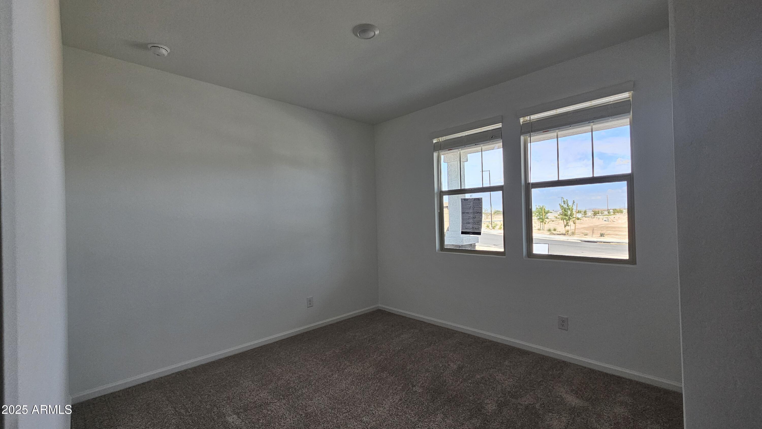 6443 East Fiddleneck Street San Tan Valley, AZ 85140 - Photo 5 of 26 an empty room with a window