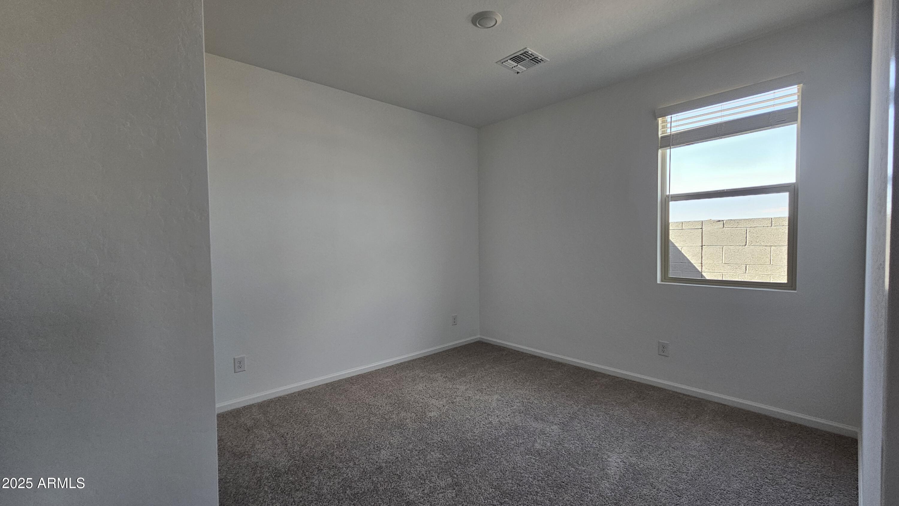 6443 East Fiddleneck Street San Tan Valley, AZ 85140 - Photo 7 of 26 an empty room with a window