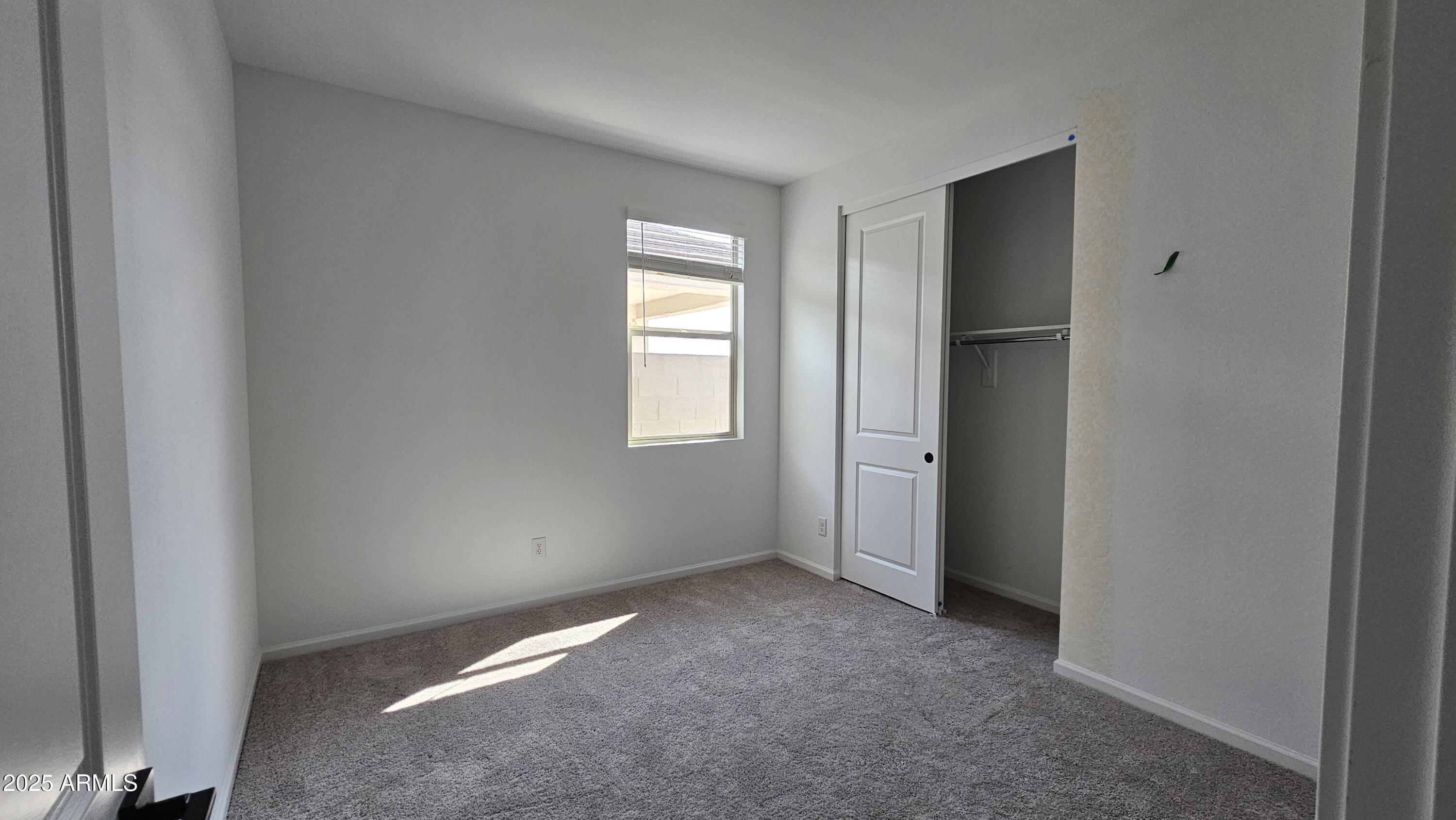 6443 East Fiddleneck Street San Tan Valley, AZ 85140 - Photo 10 of 26 a view of an empty room with closet and a window
