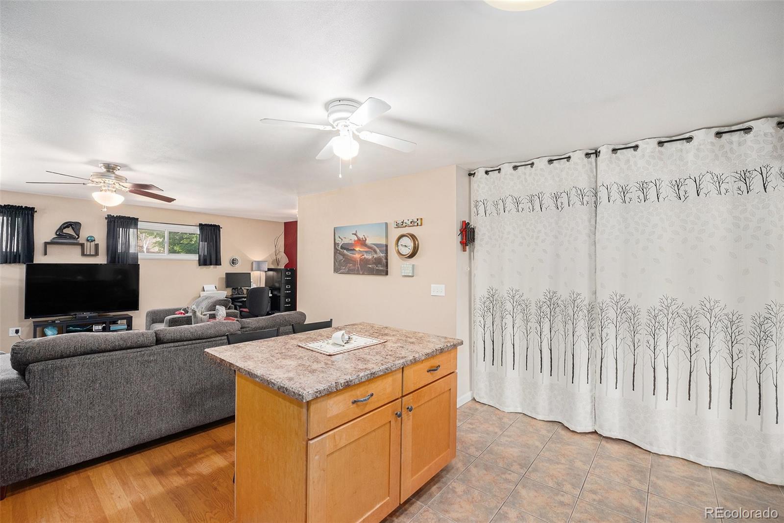 8601 Cedar Lane Westminster, CO 80031 - Photo 11 of 20 a living room with granite countertop furniture and a flat screen tv