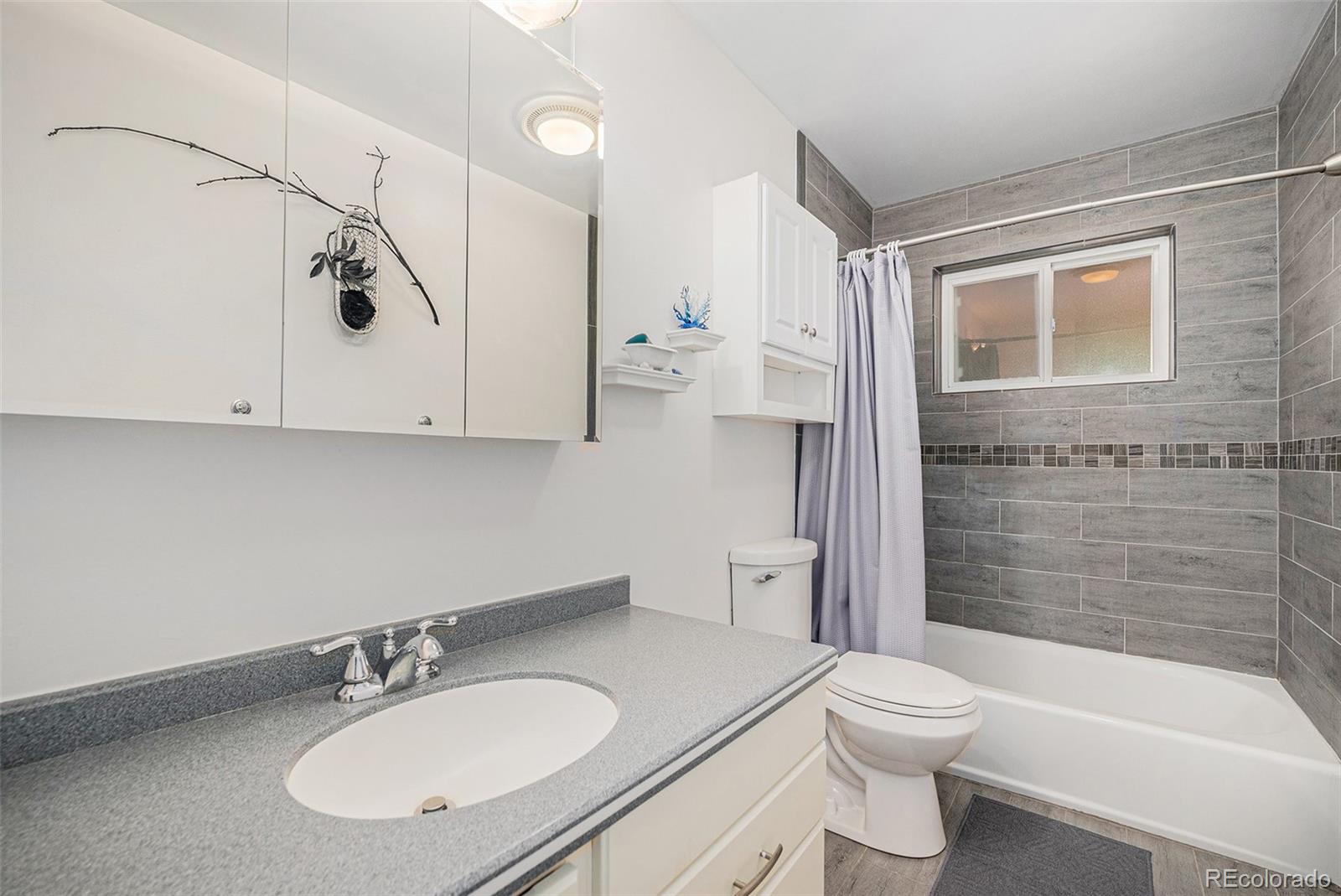8601 Cedar Lane Westminster, CO 80031 - Photo 16 of 20 a bathroom with a sink a toilet and shower