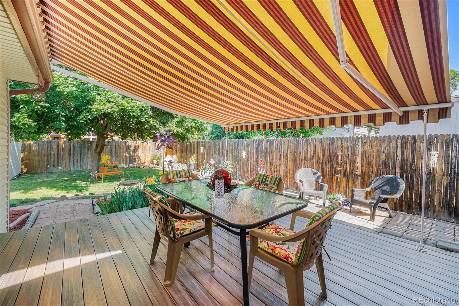 8601 Cedar Lane Westminster, CO 80031 - Photo 17 of 20 a patio with wooden table and chairs
