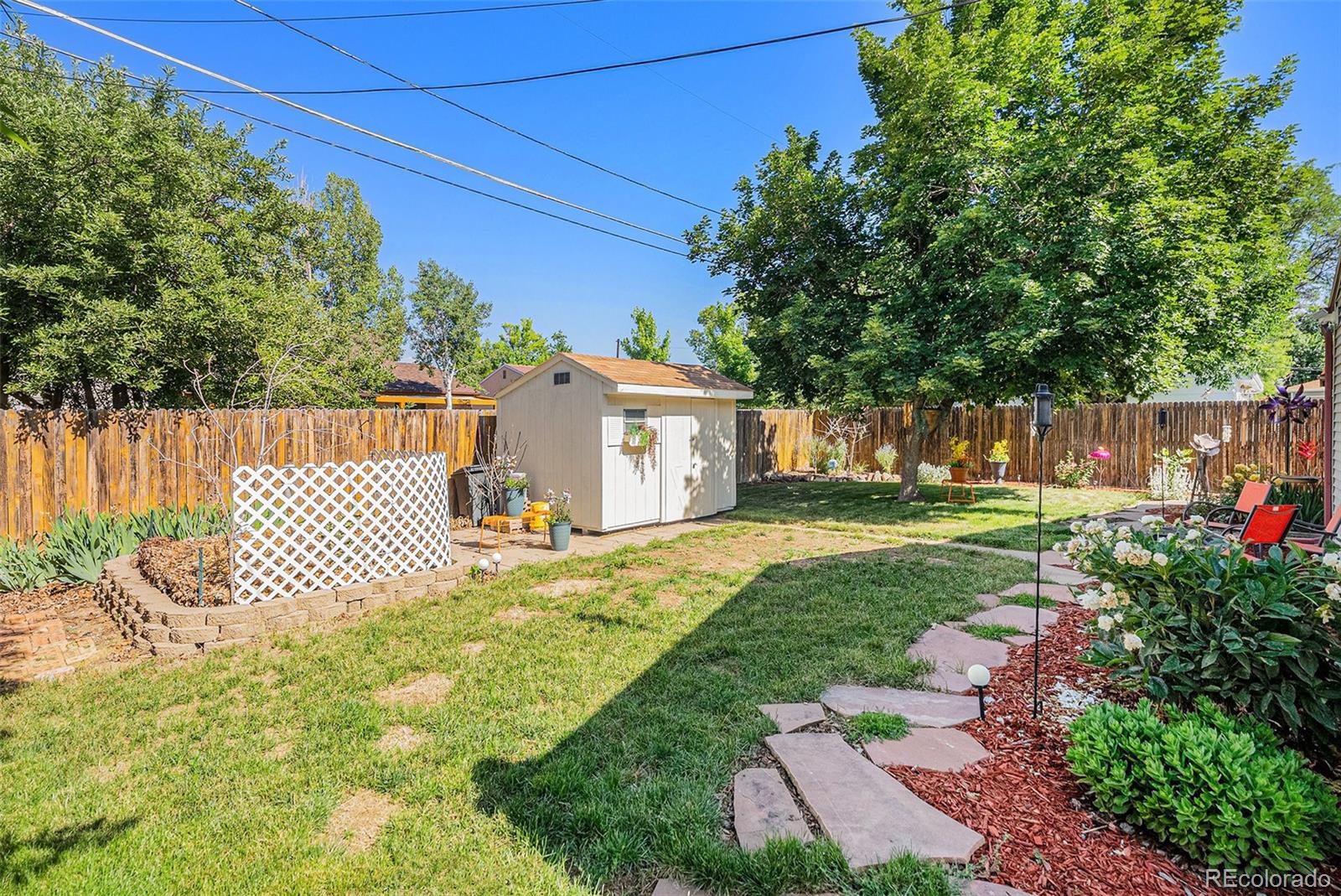 8601 Cedar Lane Westminster, CO 80031 - Photo 18 of 20 a front view of a house with a garden