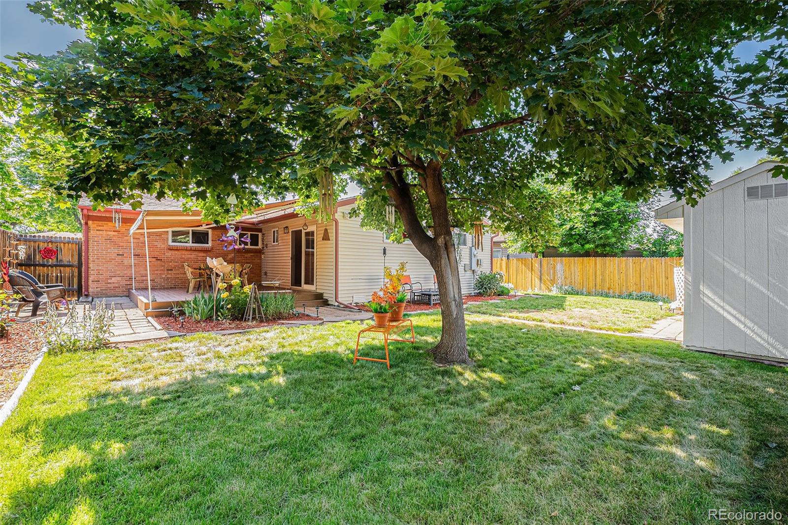 8601 Cedar Lane Westminster, CO 80031 - Photo 19 of 20 a view of backyard with a garden and trees