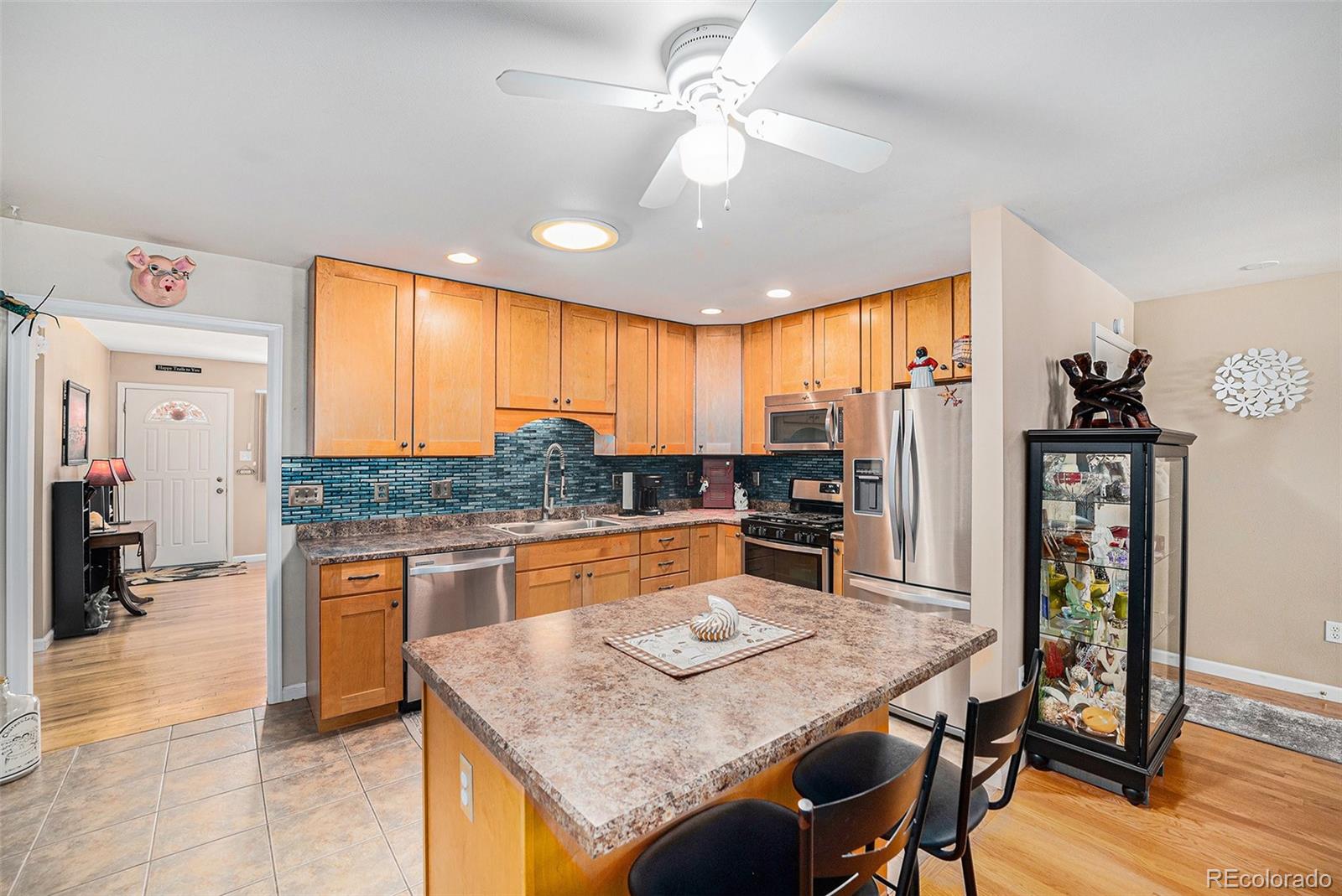 8601 Cedar Lane Westminster, CO 80031 - Photo 8 of 20 a kitchen with stainless steel appliances granite countertop a stove refrigerator and cabinets