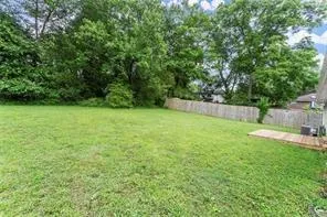 a view of a yard with a house and large trees