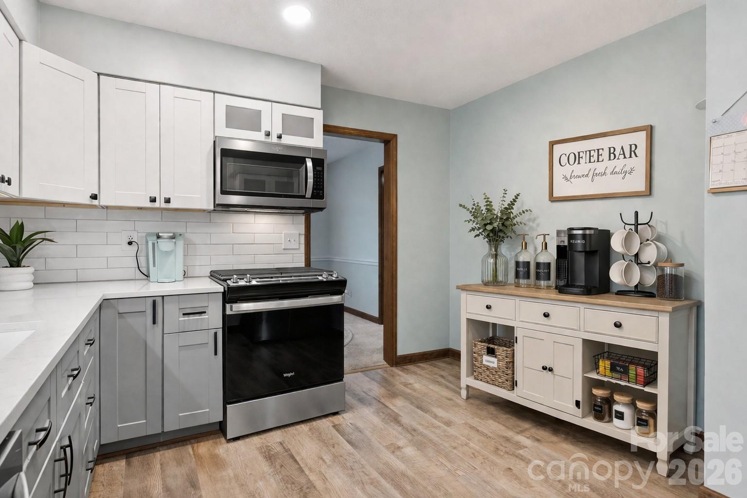107 Friendfield Drive Fort Mill, SC 29715 - Photo 11 of 36 a kitchen with stainless steel appliances white cabinets and a stove top oven
