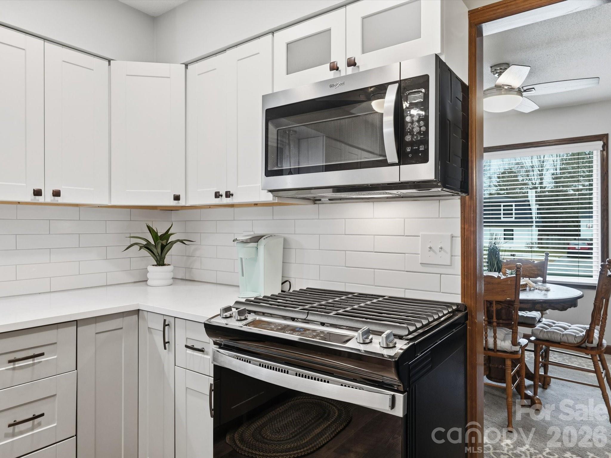 107 Friendfield Drive Fort Mill, SC 29715 - Photo 11 of 40 a kitchen with stainless steel appliances a stove a microwave sink and cabinets