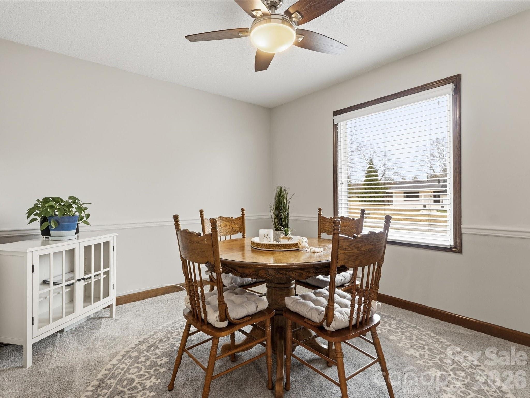 107 Friendfield Drive Fort Mill, SC 29715 - Photo 15 of 40 a view of a dining room with furniture window and wooden floor