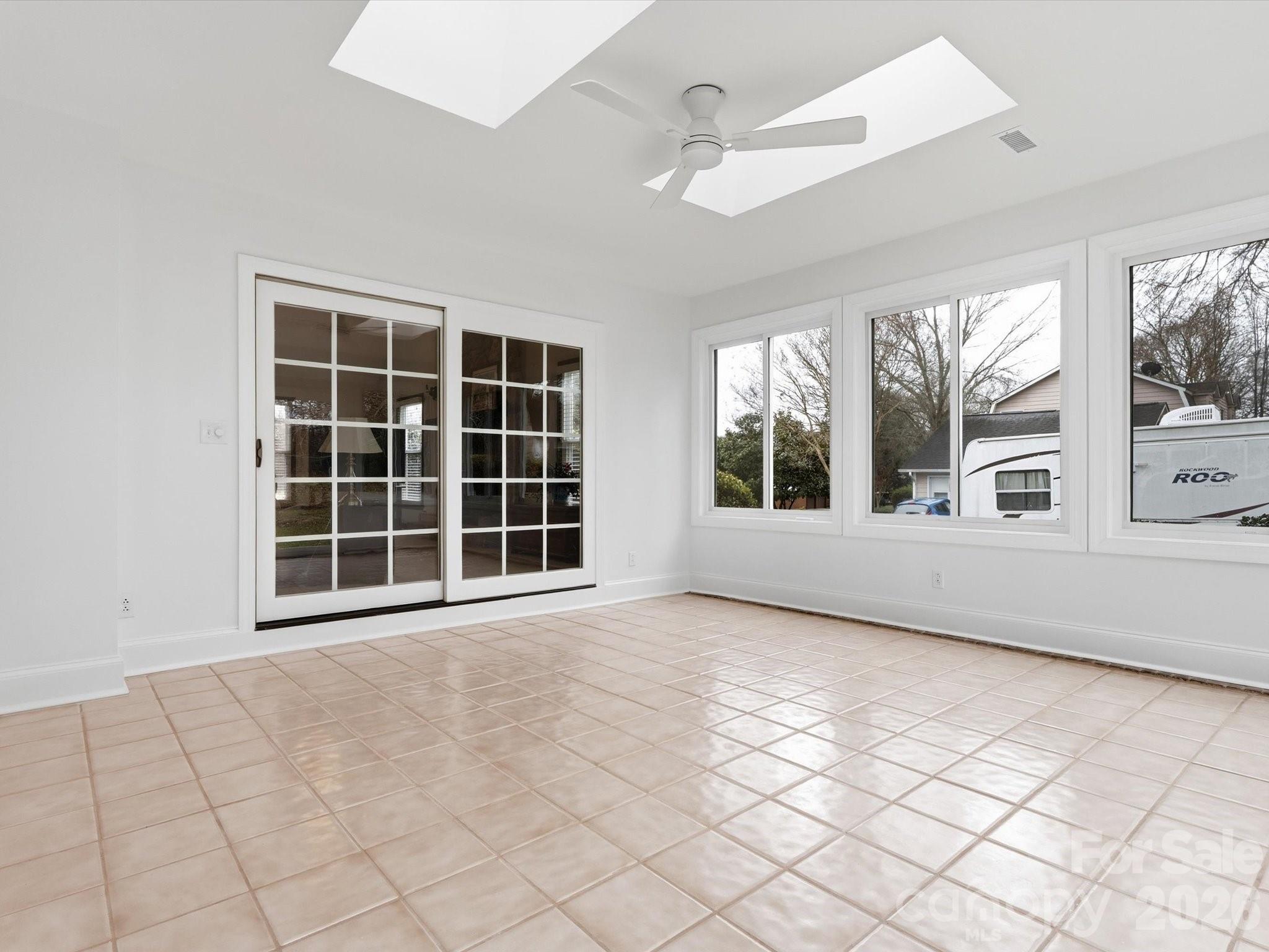 107 Friendfield Drive Fort Mill, SC 29715 - Photo 23 of 36 a view of an empty room with a window and kitchen view