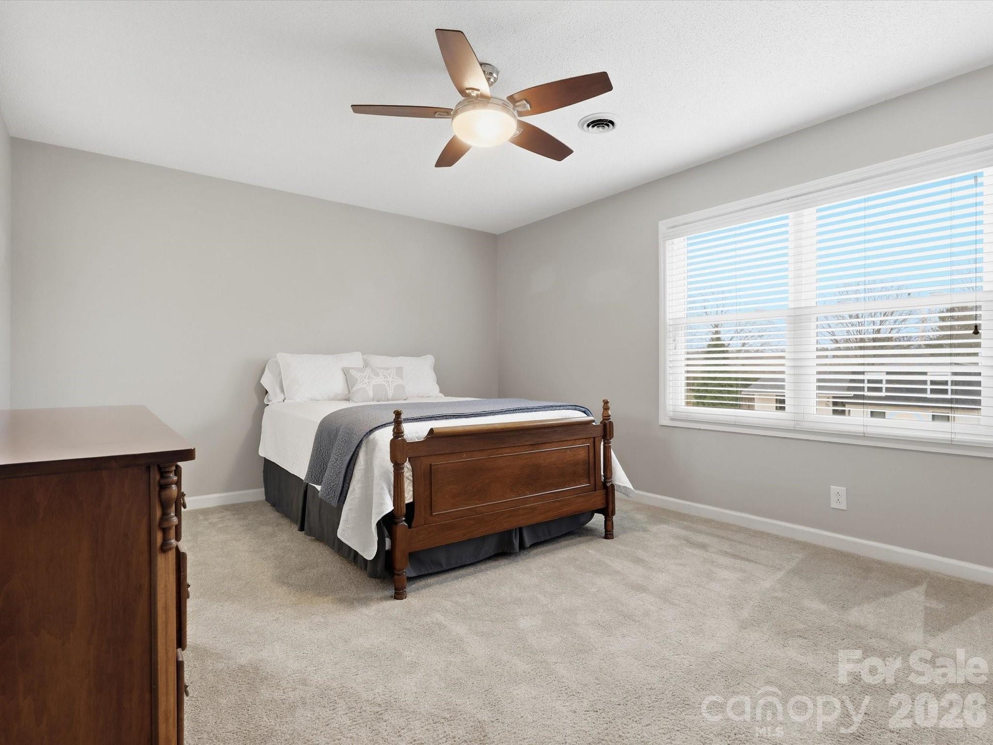 107 Friendfield Drive Fort Mill, SC 29715 - Photo 26 of 40 a bedroom with a bed and a large window