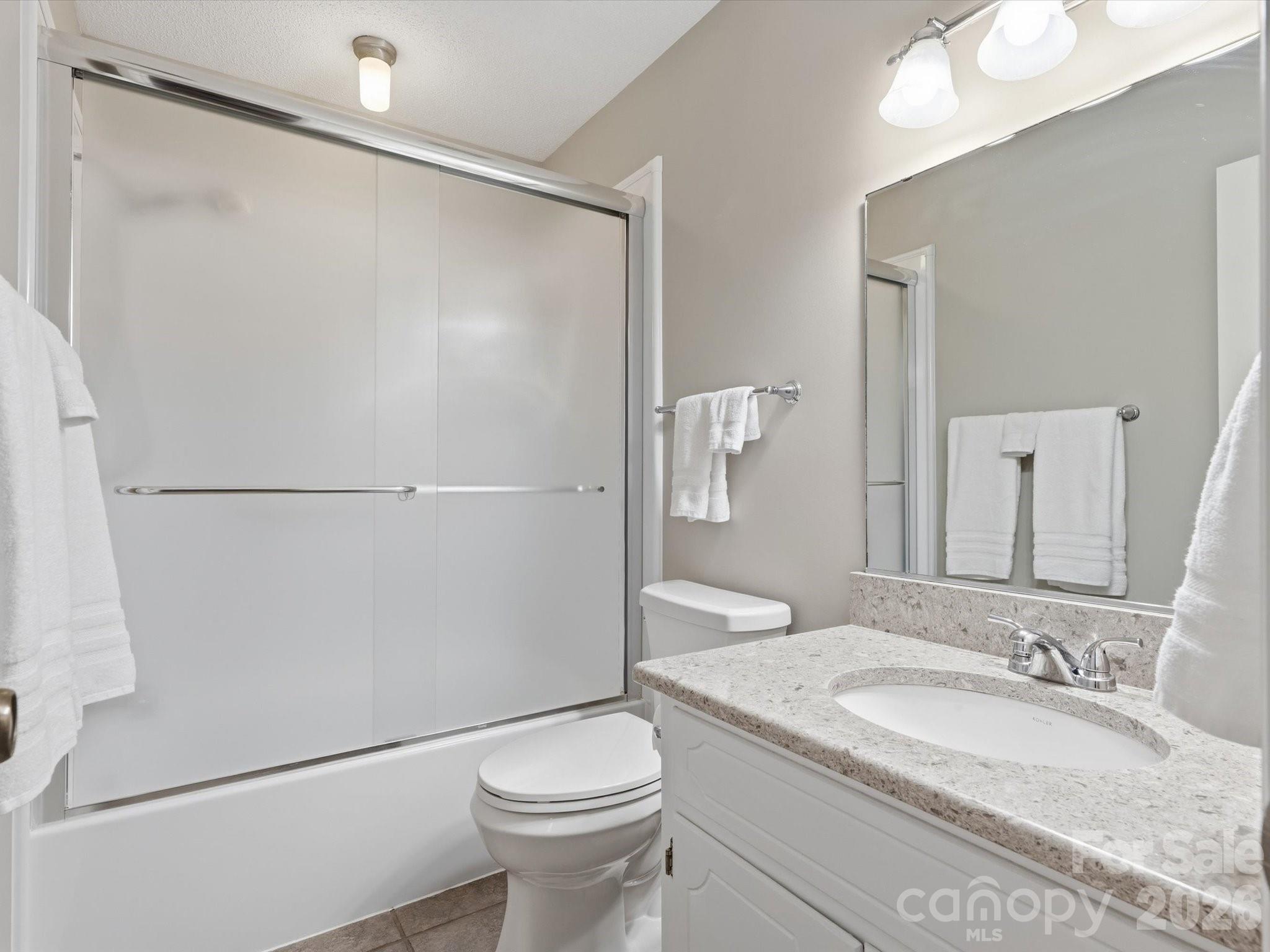 107 Friendfield Drive Fort Mill, SC 29715 - Photo 31 of 36 a bathroom with a granite countertop sink toilet and shower