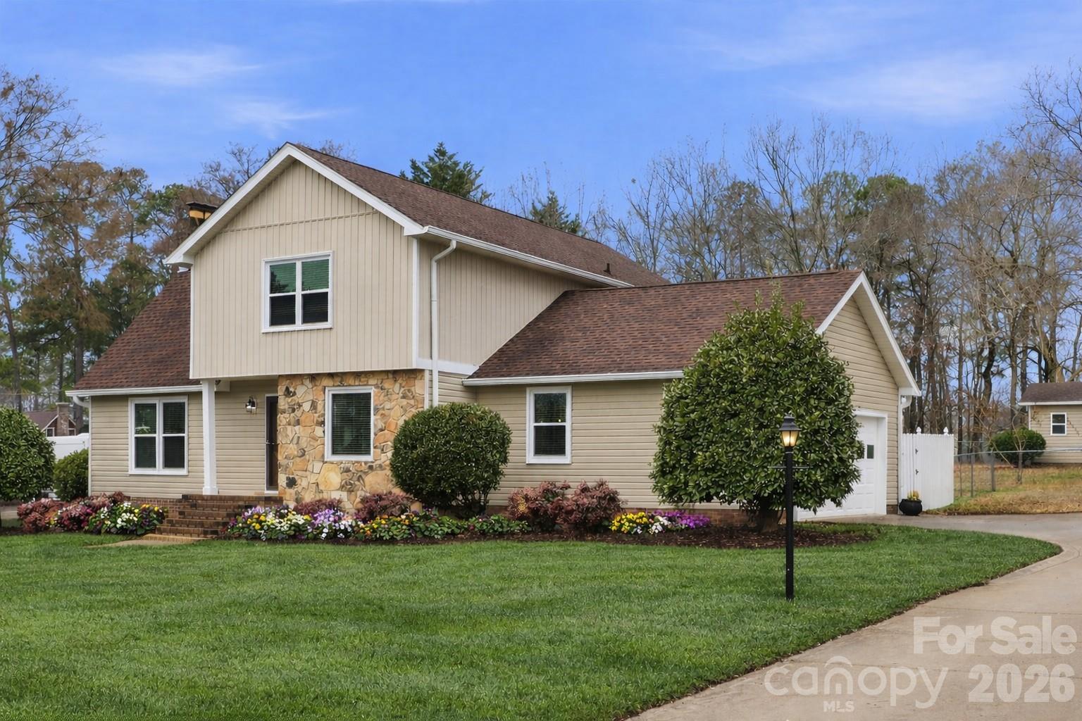 107 Friendfield Drive Fort Mill, SC 29715 - Photo 4 of 36 a front view of a house with a garden and plants