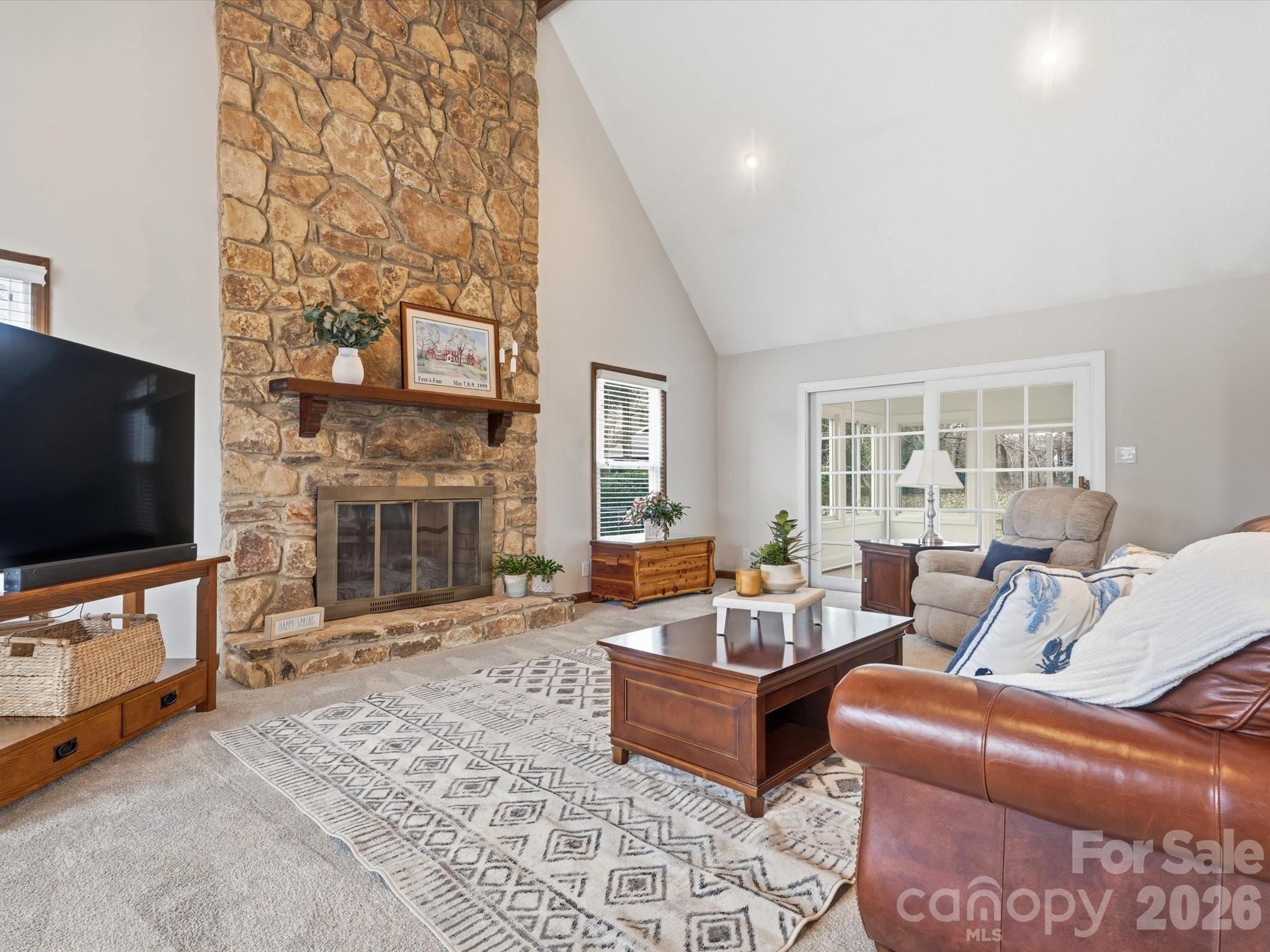 107 Friendfield Drive Fort Mill, SC 29715 - Photo 6 of 40 a living room with furniture a flat screen tv and a fireplace