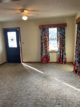 an empty room with windows and closet