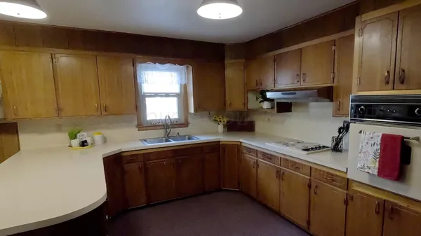 a kitchen with stainless steel appliances a sink dishwasher stove and cabinets