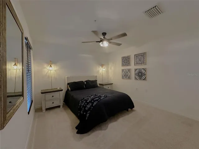 a bedroom with a bed and a chandelier