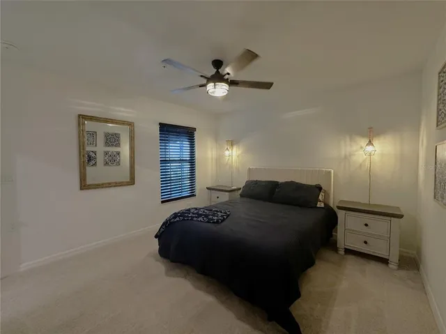 a bedroom with a bed and a lamp